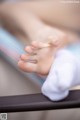 A close up of a baby's foot on a table.